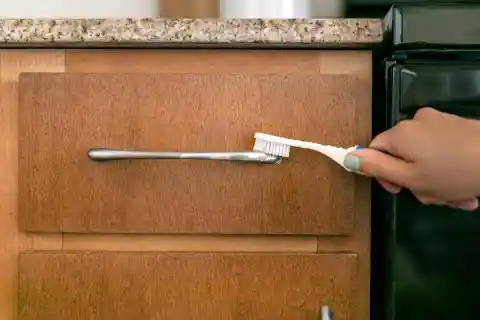 Using A Toothbrush For Cabinet Knobs